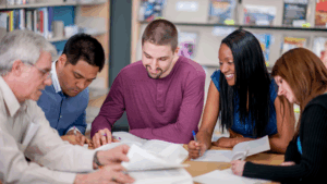 A teacher and students working at a table